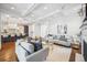 Open concept living room with coffered ceilings, hardwood floors, and view to the kitchen at 1131 S York St, Denver, CO 80210