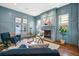 Stylish living room with custom wainscotting, a cozy fireplace, and ample natural light, perfect for relaxing at 1131 S York St, Denver, CO 80210