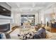 Bright living room with fireplace, TV, hardwood floors and large glass doors to a patio at 1131 S York St, Denver, CO 80210