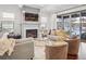 Bright living room with fireplace, TV, hardwood floors and large glass doors to a patio at 1131 S York St, Denver, CO 80210