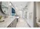 Luxury bathroom with a marble countertop vanity, freestanding tub, and glass-enclosed shower at 1131 S York St, Denver, CO 80210