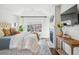 Bright main bedroom featuring fireplace, hardwood floors, vaulted ceiling, and large windows at 1131 S York St, Denver, CO 80210