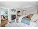 Bright main bedroom featuring fireplace, hardwood floors, vaulted ceiling, and adjacent sitting room at 1131 S York St, Denver, CO 80210
