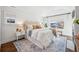 Bright main bedroom with vaulted ceilings, large windows, and a patterned area rug at 1131 S York St, Denver, CO 80210