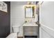 Modern powder room with shiplap accent wall, marble countertop, and gold fixtures at 1131 S York St, Denver, CO 80210
