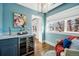 Sitting room with blue walls, wet bar, wine fridge, chandelier, and bright windows at 1131 S York St, Denver, CO 80210