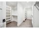 Bright, white walk-in closet with shelves and rods, for closet organization and ample storage at 1131 S York St, Denver, CO 80210
