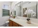 Clean bathroom with a vanity, toilet, and a window for natural light at 990 S Locust St # D, Denver, CO 80224