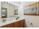 Bathroom boasts a vanity with a large mirror and plenty of light at 990 S Locust St # D, Denver, CO 80224