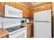 View of kitchen appliances including a microwave and stove at 990 S Locust St # D, Denver, CO 80224