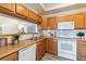 Well-equipped kitchen with wood cabinets and modern appliances at 990 S Locust St # D, Denver, CO 80224