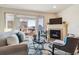 Spacious living room with a fireplace and sliding glass doors to a balcony at 990 S Locust St # D, Denver, CO 80224