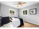 Cozy bedroom with hardwood floors, natural light, and neutral wall color at 6980 Niagara St, Commerce City, CO 80022