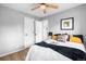 Comfortable bedroom featuring wood floors, bright light, neutral paint, and simple decor at 6980 Niagara St, Commerce City, CO 80022