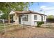 Charming home features a fenced yard with a welcoming covered porch and newly painted exterior at 6980 Niagara St, Commerce City, CO 80022