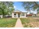 Charming home with a sidewalk leading to the front entrance, a covered porch, and a fenced yard at 6980 Niagara St, Commerce City, CO 80022