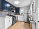 This renovated kitchen features stainless steel appliances, custom cabinets, and modern countertops at 6980 Niagara St, Commerce City, CO 80022