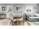 This cozy living room is open to the dining area and features neutral paint and updated flooring at 6980 Niagara St, Commerce City, CO 80022