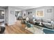The living room is open to the dining area and features neutral paint and updated flooring at 6980 Niagara St, Commerce City, CO 80022