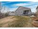Spacious backyard with lawn, a covered patio area, and attractive landscaping at 9382 Pike Way, Arvada, CO 80007