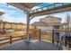 Expansive backyard with tiered landscaping, a pergola, and outdoor seating at 9382 Pike Way, Arvada, CO 80007