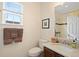 Bright bathroom includes a single vanity, framed mirror, and shower-tub combination at 9382 Pike Way, Arvada, CO 80007