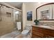 Well-appointed bathroom featuring tiled shower, glass door, and vanity with granite counter at 9382 Pike Way, Arvada, CO 80007