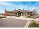 Community clubhouse showcasing architectural details, mature landscaping, and accessible parking at 9382 Pike Way, Arvada, CO 80007