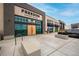 Commercial building with large glass windows, modern signage, and pedestrian friendly walkways at 9382 Pike Way, Arvada, CO 80007