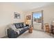 Comfortable living room area with sofa, natural light, and neutral color palette at 9382 Pike Way, Arvada, CO 80007