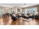 Open-concept floor plan showing the living room and dining room with hardwood floors and lots of light at 9382 Pike Way, Arvada, CO 80007