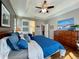 Serene bedroom featuring tray ceilings, barn door to ensuite bath, and a charming, restful decor at 9382 Pike Way, Arvada, CO 80007