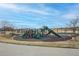 Community playground with a variety of play structures and a soft, safe surface for children at 9382 Pike Way, Arvada, CO 80007