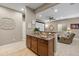 Finished basement wet bar near theater room boasts granite counters, cabinetry, and seating at 9382 Pike Way, Arvada, CO 80007