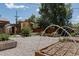 Landscaped backyard featuring a sauna, pergola, and raised garden beds for an inviting outdoor space at 1695 S Beach Ct, Denver, CO 80219