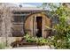 Backyard barrel sauna with glass door, wooden exterior, and surrounding greenery at 1695 S Beach Ct, Denver, CO 80219