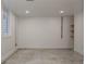 Open basement with concrete floors, window, and modern recessed lighting at 1695 S Beach Ct, Denver, CO 80219