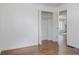 Second bedroom with hardwood floors, closet, and open door to the living room at 1695 S Beach Ct, Denver, CO 80219
