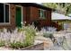 Charming brick home with green door and lovely landscaped front yard at 1695 S Beach Ct, Denver, CO 80219
