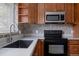 Modern kitchen features sleek appliances, neutral countertops, and a stylish backsplash at 1695 S Beach Ct, Denver, CO 80219
