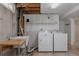 Functional laundry room with washer, dryer, sink, and countertop at 1695 S Beach Ct, Denver, CO 80219