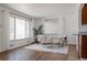 Bright living room with hardwood floors, modern furniture, and natural light from large windows at 1695 S Beach Ct, Denver, CO 80219