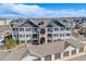 Aerial view of the townhome complex featuring the building exteriors and garages at 15700 E Jamison Dr # 6-101, Englewood, CO 80112