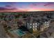 An aerial view of the condo complex, showcasing the community pool and surrounding neighborhood at sunset at 15700 E Jamison Dr # 6-101, Englewood, CO 80112