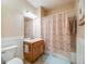 Bathroom featuring a single vanity, toilet, and shower with a patterned curtain at 15700 E Jamison Dr # 6-101, Englewood, CO 80112