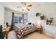 Cozy bedroom with a floral patterned quilt, ceiling fan and lots of natural light at 15700 E Jamison Dr # 6-101, Englewood, CO 80112