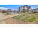 Exterior view of the community pool, showing the lawn, sidewalk, and surrounding condo buildings at 15700 E Jamison Dr # 6-101, Englewood, CO 80112