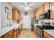 Bright kitchen featuring stainless steel appliances, oak cabinets, and ample countertop space at 15700 E Jamison Dr # 6-101, Englewood, CO 80112