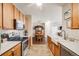 Spacious kitchen features oak cabinets, stainless appliances, and ample counter space with a view to the dining area at 15700 E Jamison Dr # 6-101, Englewood, CO 80112