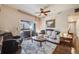 A bright living room features a sliding glass door to the balcony, plush seating, and a ceiling fan at 15700 E Jamison Dr # 6-101, Englewood, CO 80112